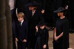 (From L) Britain's Prince George of Wales, Britain's Catherine, Princess of Wales, Britain's Princess Charlotte of Wales and Meghan, Duchess of Sussex attend the state funeral and burial of Britain's Queen Elizabeth, at Westminster Abbey in London on Monday.