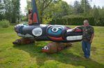 Lummi carver Jewell James stands with a totem pole he carved to urge the return of Tokitae the orca to Puget Sound.