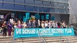 Climate plaintiffs and their attorneys in front of the Eugene Federal Courthouse in summer 2018. A sign in front of the group says "We Demand A Climate Recovery Plan."