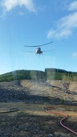 This photograph of a helicopter spraying herbicides is among hundreds whistleblower Darryl Ivy released after a month working for Applebee Aviation driving trucks and handling pesticides on Seneca Jones Timber Company sites.