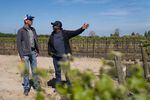Daniel Mounjoy (left), director of resource stewardship for Sustainable Conservation, a California-based nonprofit water group, talks with a colleague at a vineyard that is sinking water into the ground.