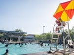 A lifeguard watches over people swimming at the Emancipation Swimming Pool in Houston City on Tuesday.