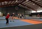 Pickleball enthusiasts practice and take classes at RECS, a new indoor pickleball complex in Clackamas, Oregon, that is drawing players from a wide bi-state area.