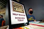 A hiring sign is placed at a booth for Jameson's Irish Pub during a job fair Wednesday, Sept. 22, 2021, in the West Hollywood section of Los Angeles.