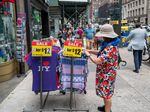 A woman shops outside of a store in Manhattan in New York City on July 28, 2022. Retail sales are starting to decline after staying strong during the pandemic, a potential early sign the economy is slowing down.
