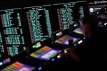A person gambles as betting odds for NFL football's Super Bowl are displayed on monitors at the Circa resort and casino sports book Friday, Feb. 3, 2023, in Las Vegas.