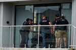 Law enforcement search in a building after a mass shooting at the Highland Park Fourth of July parade in downtown Highland Park, Ill., a Chicago suburb on Monday, July 4, 2022. (AP Photo/Nam Y. Huh)