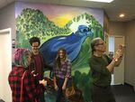Campaign supporters gather Wednesday, April 6, 2016, for presidential hopeful Sen. Bernie Sanders at the opening of his fourth office in Oregon. A mural at the office references a recent campaign visit in Oregon, where a bird spontaneously landed on the podium as Sanders spoke.