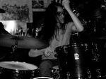 Lauren K. Newman doing what she does best, thrashing on the drums. 