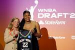Oregon's Nyara Sabally, on the right, poses for a photo with WNBA commissioner Cathy Engelbert at the 2022 draft.
