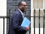 Britain's Chancellor of the Exchequer Kwasi Kwarteng leaves 11 Downing St. in London, Friday, before announcing plans to Parliament.