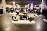 A custom motorcycle sits atop a white display platform at the One Motorcycle Show in Portland, Ore., Friday, Feb. 7, 2020.