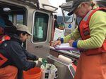 Researchers Angie Munguia, left, and Laurie Weitkamp collect and sample juvenile salmon from the lower Columbia River.