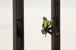 An ironworker scales a column during construction of a municipal building in Norristown, Pa. on Feb. 15, 2023.