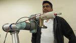 In this image collected from video footage in November 2022, biological and agricultural engineering student Uddhav Bhattarai programs a robotic arm to trim apple blossoms at the Irrigated Agriculture Research and Extension Center in Prosser, Washington. 