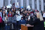 Anti-vaccine advocates rally outside the Washington State Capitol in Olympia.
