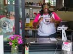 Nikeisah Newton talks with customers during the Come Thru BIPOC market at The Redd on May 17, 2021. Newton founded Meals 4 Heels in 2019, a meal delivery service catering to Portland’s sex worker community. Newton has since started serving food from a space at The Redd.