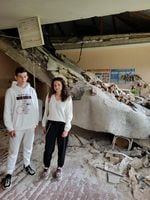 Vova Hrabovenko, 17, and his teacher Viktoria Timoshenko in what's left of her biology classroom after Russian shelling. "I didn't recognize it at first," she says.