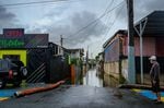A man looks at a flooded street in the Juana Matos neighborhood of Catano, Puerto Rico.
