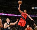 Portland Trail Blazers guard CJ McCollum, right, flies over Denver Nuggets forward Mason Plumlee for a basket in the second half of Game 7 of an NBA basketball second-round playoff series Sunday, May 12, 2019, in Denver. The Trail Blazers won 100-96. Recent reports say that McCollum is leaving the Blazers for the New Orleans Pelicans.