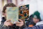 A patron reads a book they chose from the Street Books library in February.