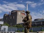 A Russian serviceman patrols Zaporizhzhia Nuclear Power Station on May 1. A series of exchanges in recent weeks has made conditions at the plant more dangerous.