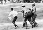 A man is chased by three Portland policemen during the 1967 Irving Park riot in Albina, an event that had begun as a peaceful rally by black activists.
