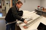 OSU marine geologist Chris Goldfinger shows an offshore sediment core, fat tube on right, and skinnier cores from Pacific Northwest lake bottoms, all of which contain traces of ancient earthquakes.