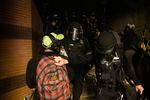 A Portland police officer pushes a National Lawyers Guild legal observer at a recent protest.