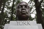A close up of a sculpture of a man's bust, sitting on a stand that reads "York."