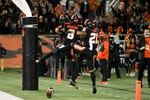 Oregon State's Tyjon Lindsey (1), Trevon Bradford (8), and Trey Lowe (21) celebrate Bradford's touchdown during the second half of the team's NCAA college football game against Utah on Saturday, Oct. 23, 2021, in Corvallis, Ore.