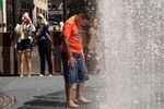People play in artist Jeppe Hein's water-based sculpture titled Changing Spaces at Rockefeller Center Plaza in New York City on Tuesday.