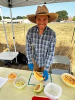 Matt Davis, an OSU research assistant, slices up dry-farmed melons at a recent event at the Oak Creek Center for Urban Horticulture.