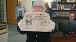 Jan Wright of the Southern Oregon Historical Society holds a newspaper from 1950 found inside the time capsule.