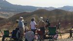 Visitors watch and photograph the eclipse in Oregon's Painted Hills.