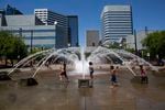 Children play in the fountain at the Portland Water front as the temperature rises to more than 100 degrees fahrenheit