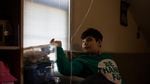 Colin, 12, looks out the window of his brother's room in their family home in Vancouver, Wa., Saturday, March 2, 2019.