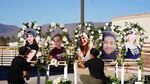 Two people put up a memorial with photographs of the five victims of a weekend mass shooting at a nearby gay nightclub on Tuesday, Nov. 22, 2022, in Colorado Springs, Colo.