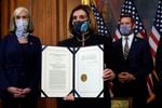 House Speaker Nancy Pelosi of Calif., displays the signed article of impeachment against President Donald Trump in an engrossment ceremony before transmission to the Senate for trial on Capitol Hill, in Washington, Wednesday, Jan. 13, 2021.