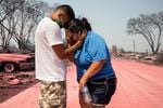Dora Negrete is consoled consoled by her son Hector Rocha after seeing their destroyed mobile home at the Talent Mobile Estates, Thursday, Sept. 10, 2020, in Talent, Ore., after wildfires devastates the region.