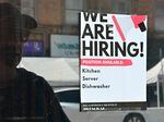 A "We Are Hiring" sign is posted in front of a restaurant in Los Angeles on Aug. 17, 2022. The labor market remains resilient, raising hopes that any recession would be mild.