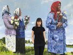 Ukrainian artist Tatyana Ostapenko stands in front of her mural titled "Real Strong and Silent Types," in Portland, Oregon. She will create a new painting during Amelia Lukas's concert "Natural Homeland Honoring Ukraine" Thursday April 6, 2023 at the Alberta Rose Theatre.