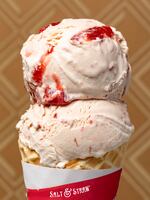 A cone full of Salt & Straw's Strawberry Honey Balsamic with Black Pepper ice cream.