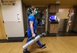 Nurse Danielle LaRocco carries an oxygen tank to the room of a COVID-19 patient on the acute care floor at Salem Health in Salem, Ore., Jan. 27, 2022. Some hospitals are feeling the strain due to the recent surge of coronavirus, such as Salem Health, which had had 540 patients, but only 494 beds available.