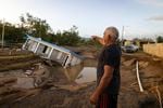 A man points to a home that was collapsed by Hurricane Fiona at Villa Esperanza in Salinas, Puerto Rico, Wednesday, September 21, 2022.