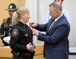 Retired Multnomah County sheriff’s deputy Bob O’Donnell, right, pins the badge on his wife, Nicole Morrisey O’Donnell. Morrisey O’Donnell spent 26 years with the Multnomah County Sheriff’s Office before being elected to the top job. At her swearing-in ceremony she said she’s focused on improving public trust and building bridges among community partners.