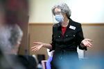 Kathy Watson, director of health services at Friendsview Retirement Community in Newberg, Ore., talks with residents in the observation area during a COVID-19 vaccination clinic on Feb. 5, 2021. 