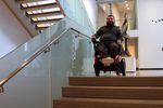 Disability rights advocate Joseph Lowe shows how the warren of stairs and elevators make the museum difficult to navigate for individuals with mobility challenges.