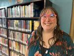 Ellen Brigham, the Columbia County Library interim director, stands near the current young adult section at the library.