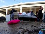 A woman looks at her water-damaged belongings after flooding caused by Hurricane Fiona tore through her home in Toa Baja, Puerto Rico, on Tuesday.